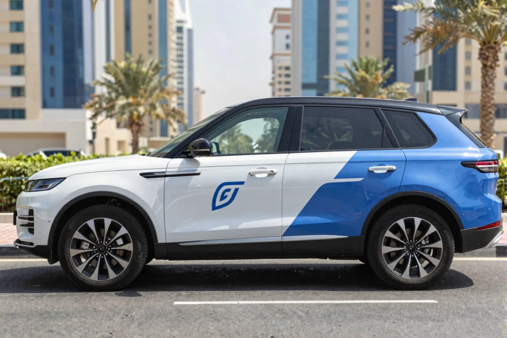 A modern SUV with professional blue and white vinyl branding parked on a sunny Dubai street with skyscrapers in the background